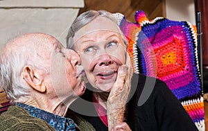 Elderly Gentleman Kissing Elderly Woman on Cheek