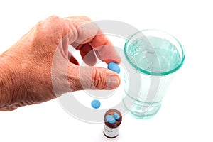 Elderly hand is taking medicine