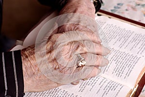 Elderly hands on bible