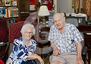 Elderly happily married couple celebrating the wife`s 87th birthday in their home.