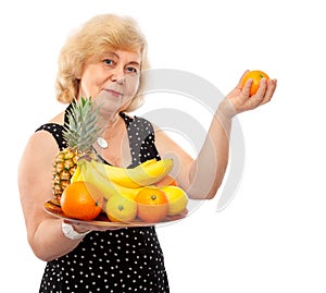 Elderly happy woman treat fresh fruits