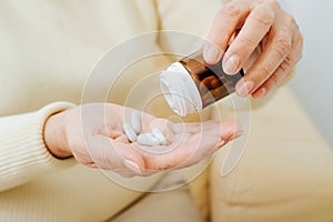 Elderly and healthcare, pharmaceutical treatment. Senior sick woman holds medicine capsules
