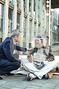 Elderly hippy fugitive talking to governmental worker