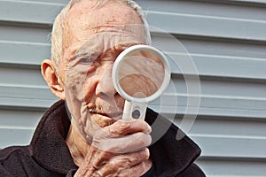 The elderly Holding a magnifying glass