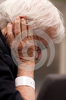 Elderly hospital patient wearing wristband