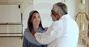 Elderly Indian doctor man listening to heartbeat rate of patient