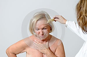 Elderly lady gets her hair combed