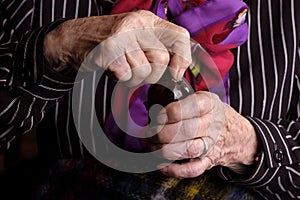 Elderly lady opening a medicine bottle