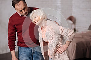 Elderly lady with pain near her husband.