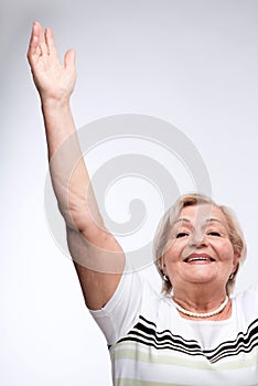 Elderly lady raising hands