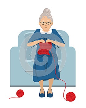 Elderly lady is sitting in a blue armchair and knits