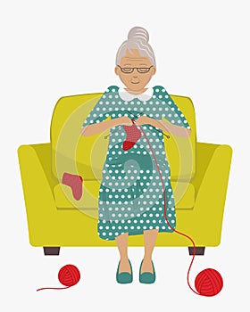 Elderly lady is sitting in yellow armchair and knits socks