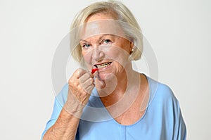 Elderly lady using interdental brush