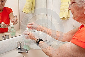 Elderly Lady Washing her Hands with Liquid Soap