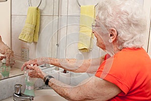 Elderly Lady Washing her Hands with Liquid Soap