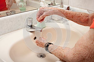 Elderly Lady Washing her Hands with Liquid Soap