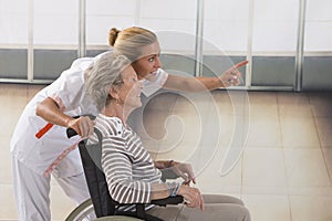 Elderly lady on wheelchair and her care giver