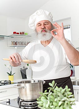 Elderly male chef in kithen