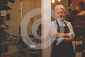 An elderly man an apron