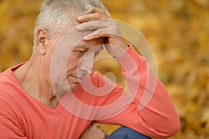 Elderly man on autumn background