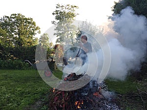 Elderly man with autumn bonfire