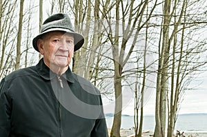Elderly Man on Beach with Trees