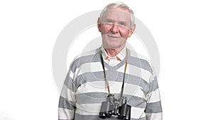 Elderly man with binoculars, white background.