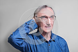 Elderly man in a blue denim shirt