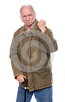 Elderly man with a cane threatening with a fist