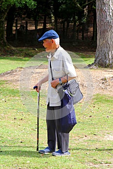 Elderly man cap walking stick park, Japan