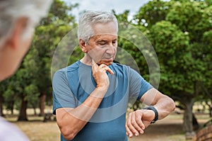 Elderly man checking pulse after running