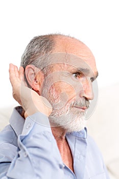 Elderly man with a deaf-aid