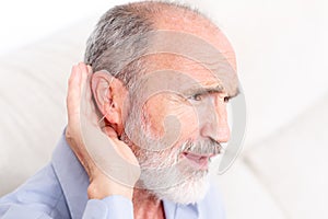 Elderly man with a deaf-aid