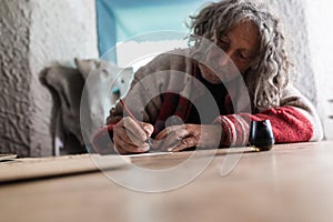 Elderly man doing calligraphy using a nib pen