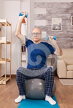 Elderly man doing sport in pajamas