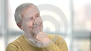 Elderly man dreaming on blurred background.