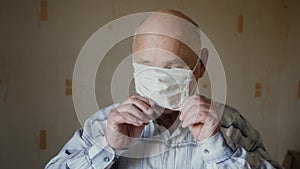 Elderly man dressing up protective mask