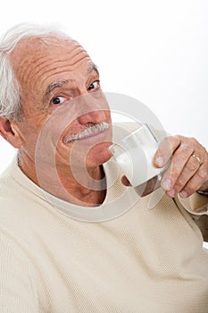 Elderly man drinking milk