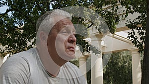 Elderly man drinks water bottles