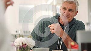 Elderly man eating breakfast, home at table and healthy couple happy in dining room together. Morning conversation