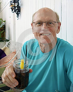 Elderly man enjoys a soda