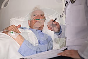 Elderly man examined by doctor