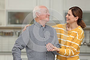 Elderly man with female caregiver