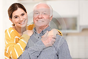 Elderly man with female caregiver
