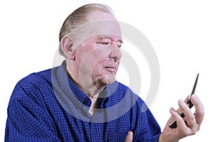 Elderly man figuring out cell phone photo
