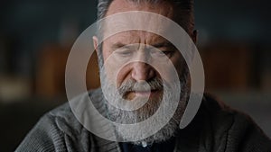 Elderly man getting information at home. Greyhaired man working remotely indoors