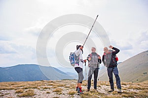 An elderly man giving a tour for a young group of people