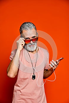 An image of an elderly man listening to music with headphones