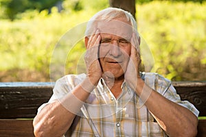Elderly man has headache.