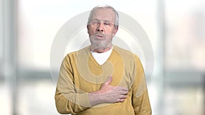 Elderly man having pain in chest.